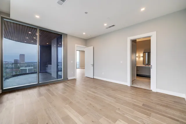 a bedroom with a bed and a large window