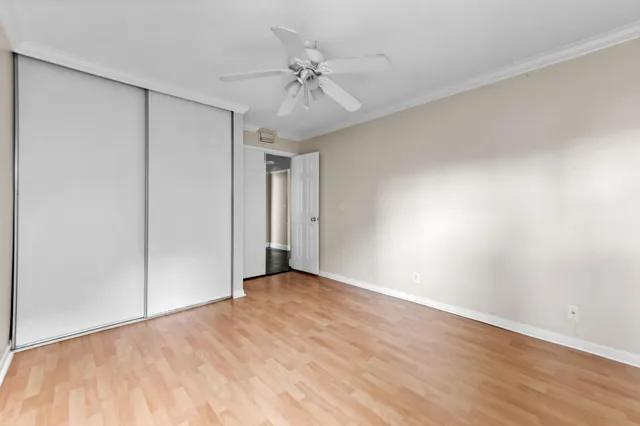 a view of an empty room with a ceiling fan
