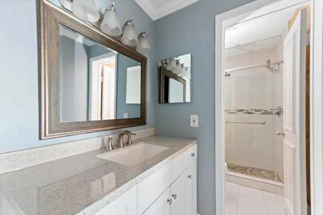 a bathroom with a granite countertop sink mirror and vanity