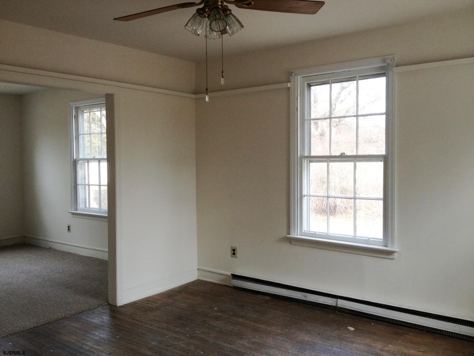 1305 A Matthews Avenue Mays Landing, NJ 08330 - Photo 4 of 14 an empty room with a window and chandelier fan