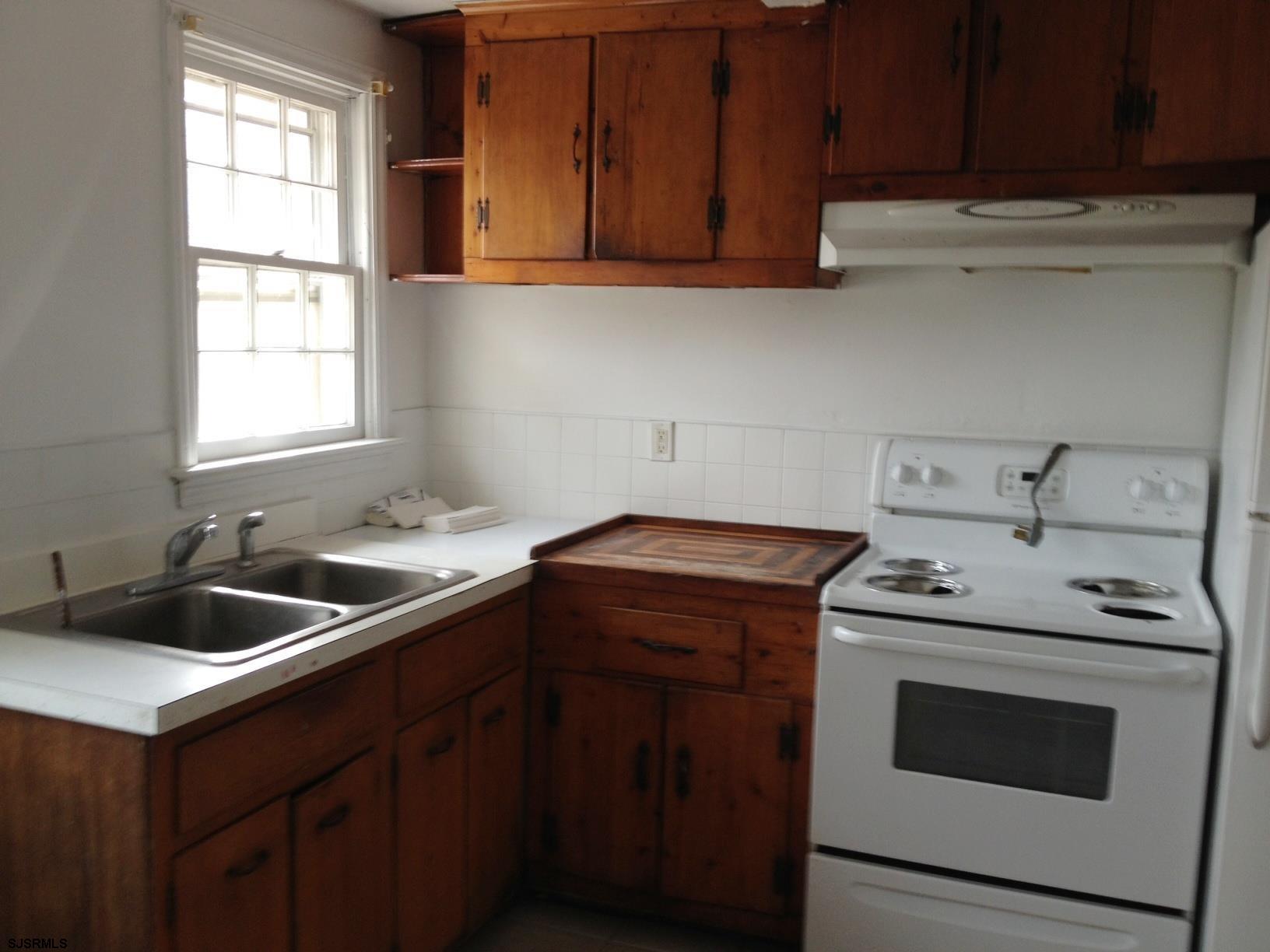 1305 A Matthews Avenue Mays Landing, NJ 08330 - Photo 5 of 14 a kitchen with a sink stove top oven and cabinets