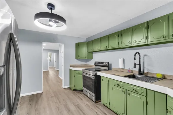 a kitchen with stainless steel appliances granite countertop a sink and cabinets