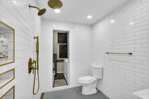 a bathroom with a toilet and a shower