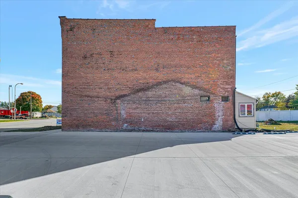 a view of a brick house with a small yard