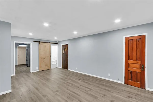 a view of hallway with wooden floor