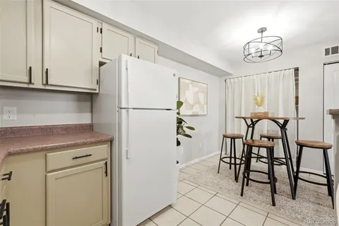 a kitchen with appliances cabinets and furniture