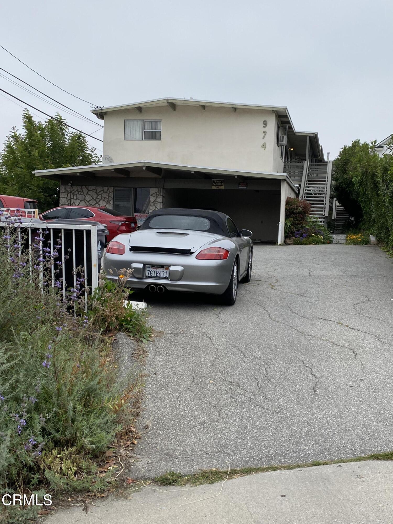 a view of garage with a car parked in it