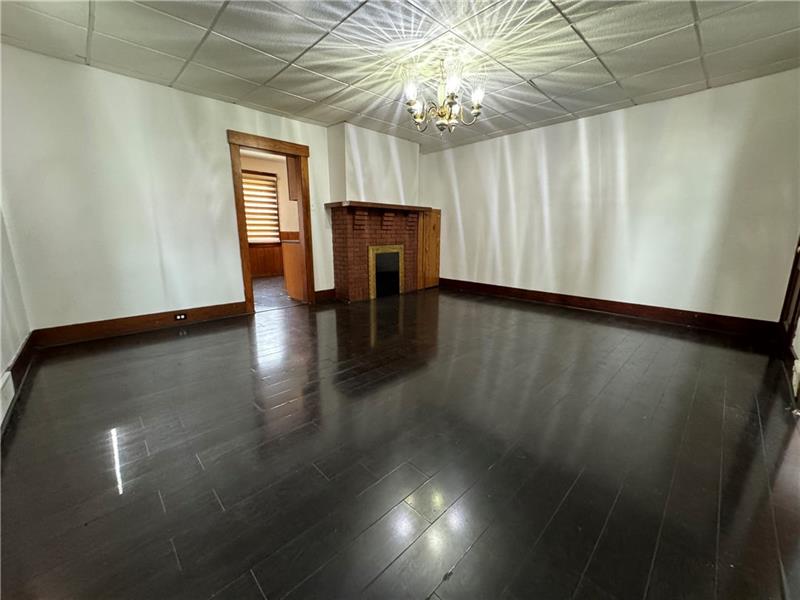 1012 11th Street McKees Rocks, PA 15136 - Photo 11 of 50 a view of livingroom with hardwood floor and window