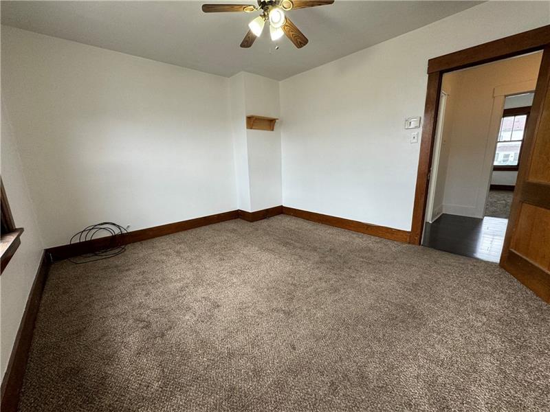 1012 11th Street McKees Rocks, PA 15136 - Photo 20 of 50 an empty room with a chandelier fan and windows