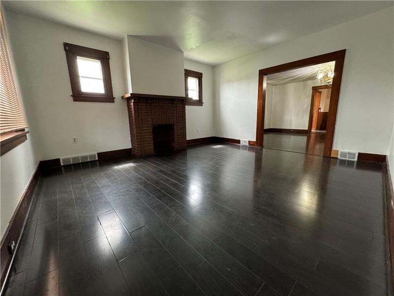 1012 11th Street McKees Rocks, PA 15136 - Photo 2 of 50 a view of a livingroom with wooden floor and a window