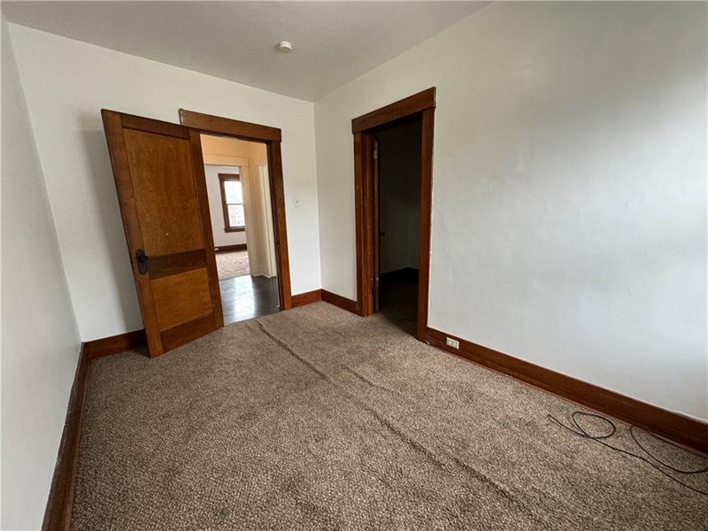 1012 11th Street McKees Rocks, PA 15136 - Photo 25 of 50 an empty room with closet and mirror