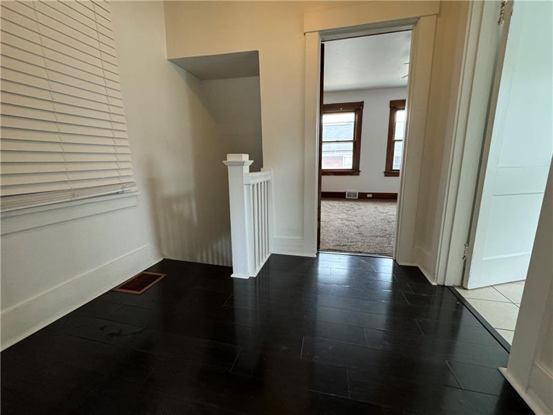 1012 11th Street McKees Rocks, PA 15136 - Photo 31 of 50 an empty room with wooden floor and a window