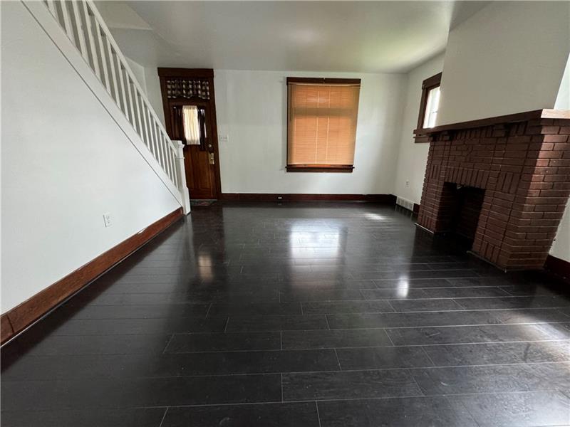 1012 11th Street McKees Rocks, PA 15136 - Photo 4 of 50 a view of a livingroom with wooden floor and a fireplace