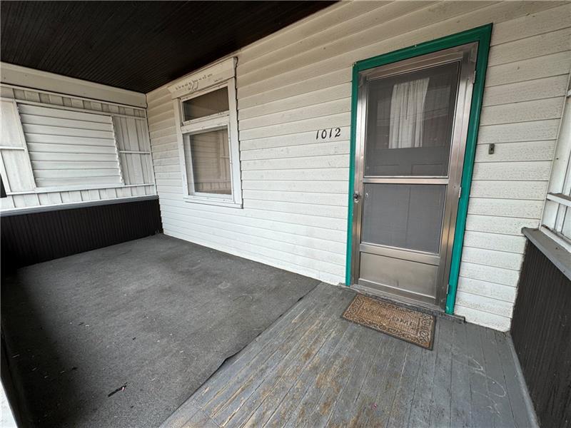 1012 11th Street McKees Rocks, PA 15136 - Photo 49 of 50 a view of an empty room with wooden floor and a window
