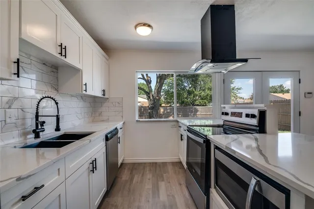 a kitchen with stainless steel appliances granite countertop a sink and stove