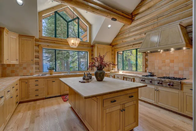 a kitchen with a stove a sink and a window