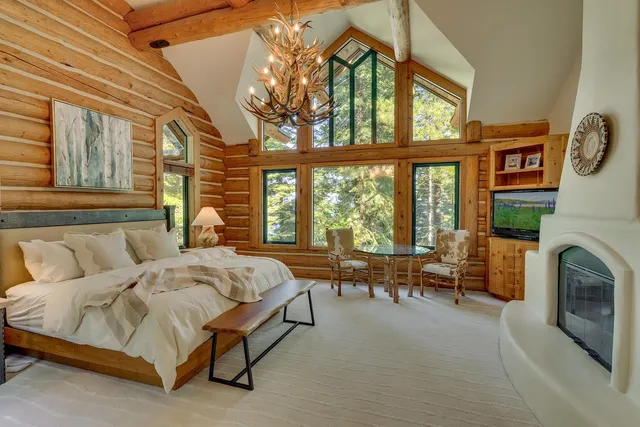 a spacious bedroom with a bed and a large window