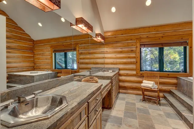 a kitchen with a sink a stove and chairs