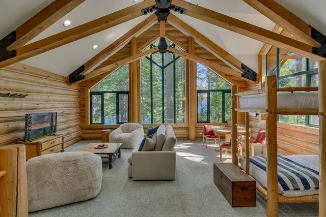 a living room with furniture and floor to ceiling windows