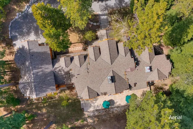 an aerial view of a house with a yard