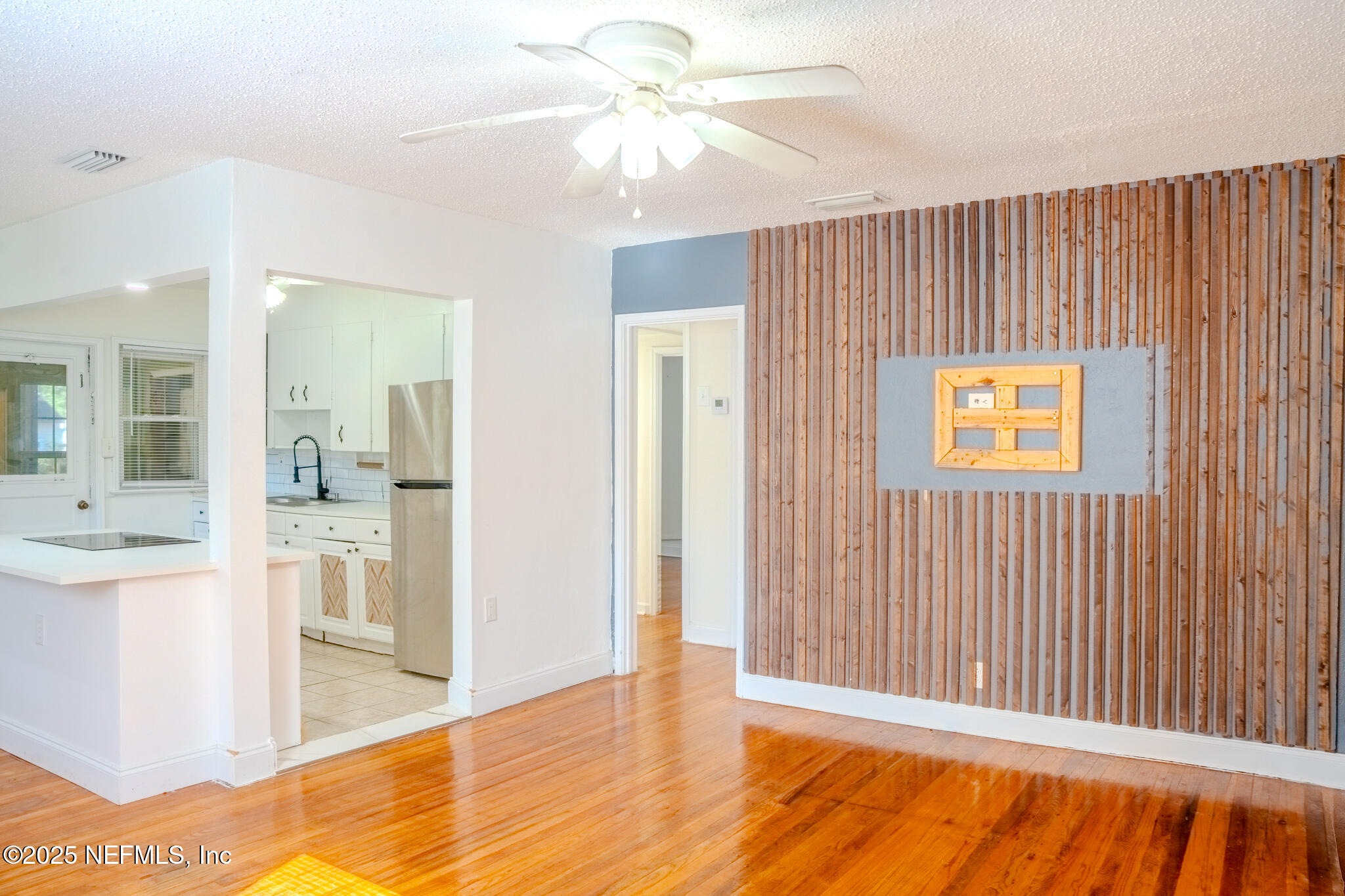 4916 Dundee Road Jacksonville, FL 32210 - Photo 5 of 16 a view of a kitchen with wooden floor and a kitchen space