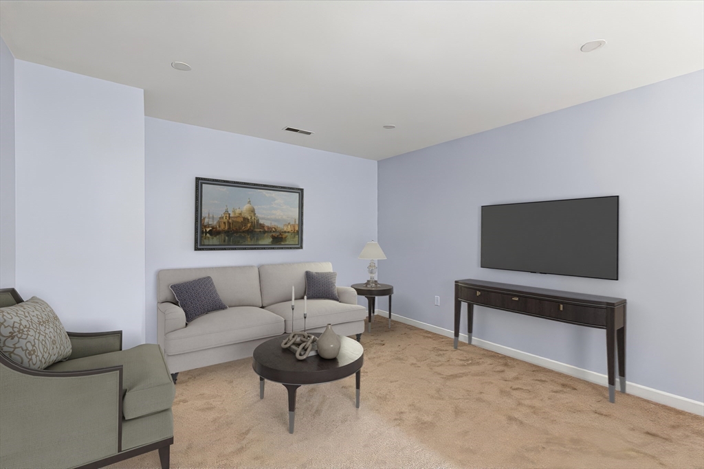 31 Fox Hollow Plymouth, MA 02360 - Photo 16 of 39 a living room with furniture and a flat screen tv