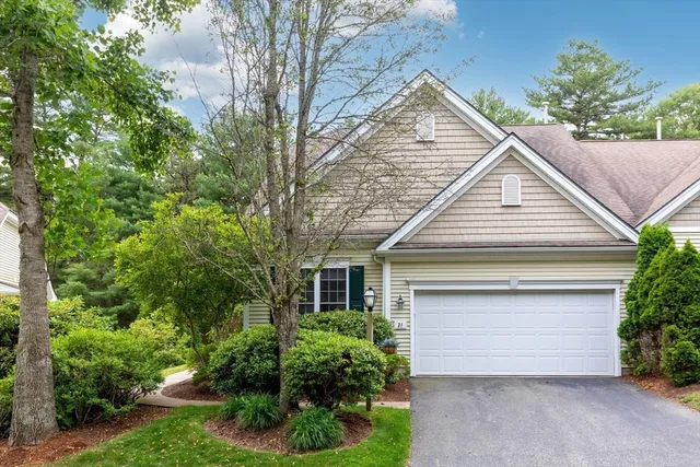 a view of house with garden and garage