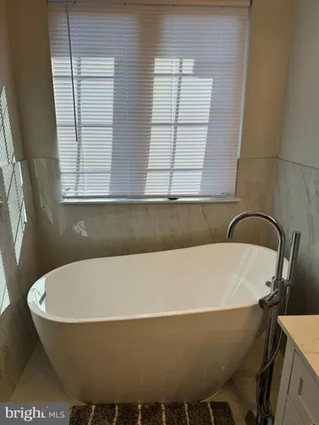 a bathroom with a bathtub and window