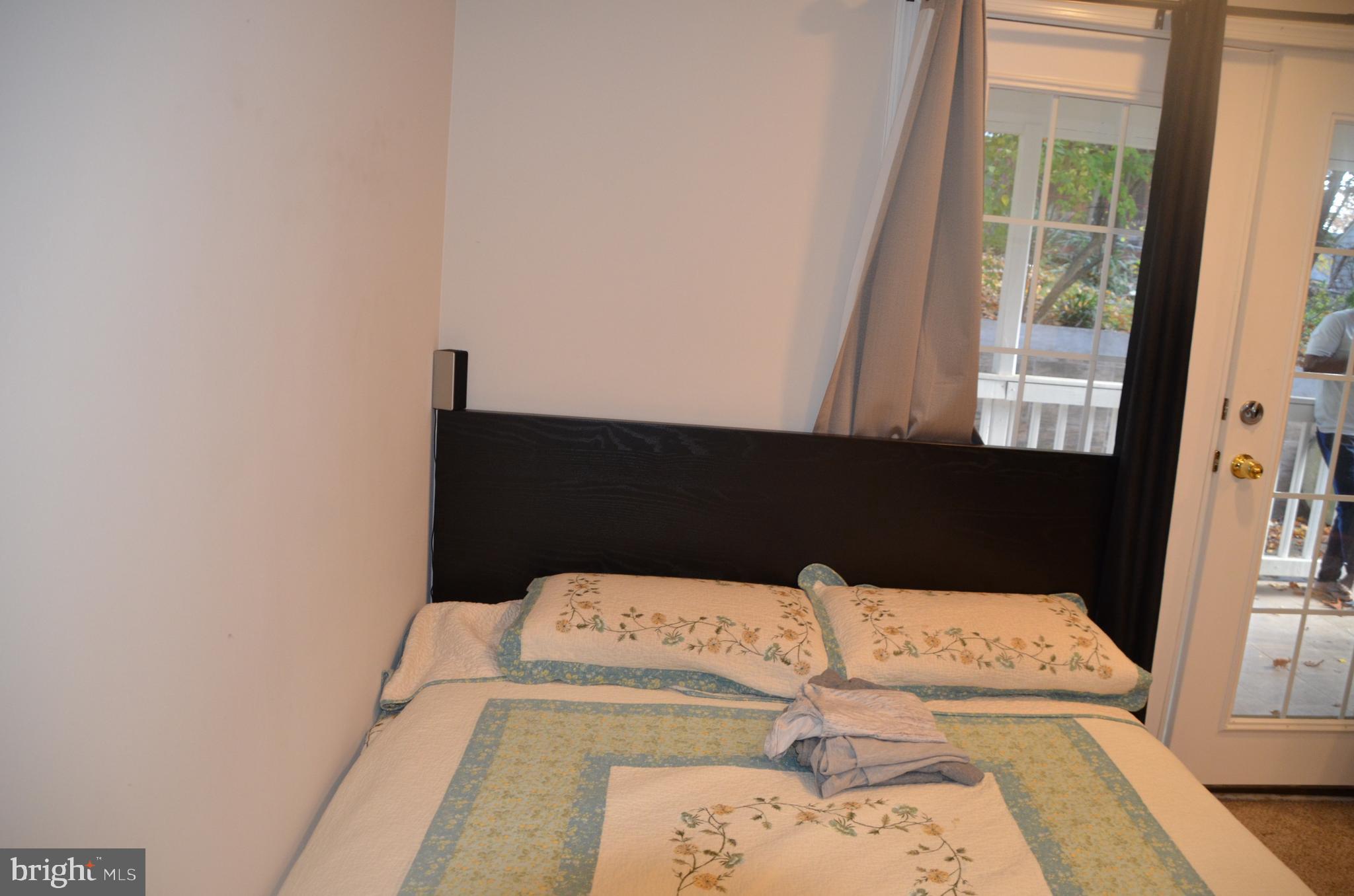 8709 Reading Road Silver Spring, MD 20901 - Photo 5 of 44 a bed sitting in a bedroom next to a window