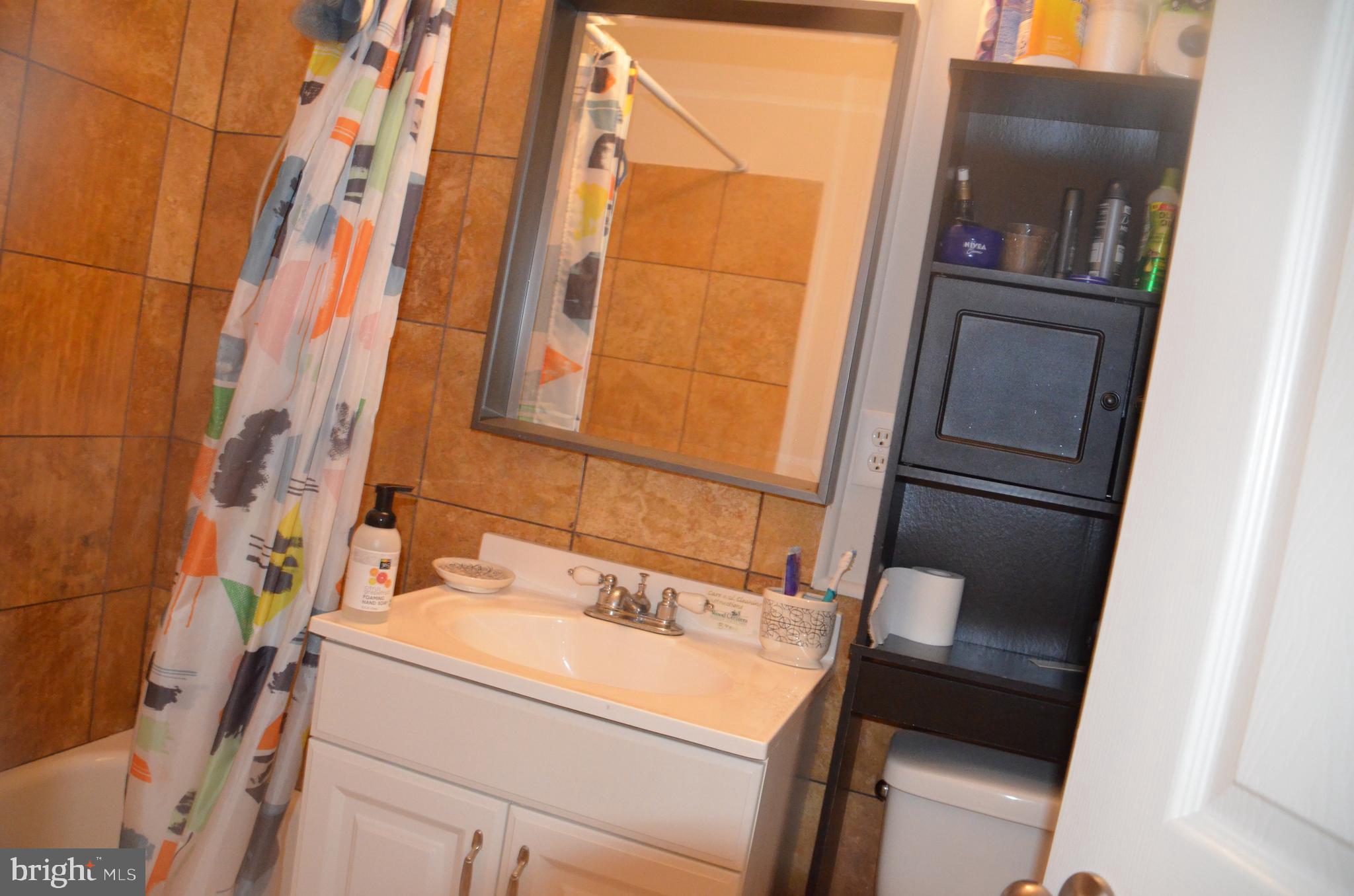 8709 Reading Road Silver Spring, MD 20901 - Photo 9 of 44 a bathroom with a sink and a mirror