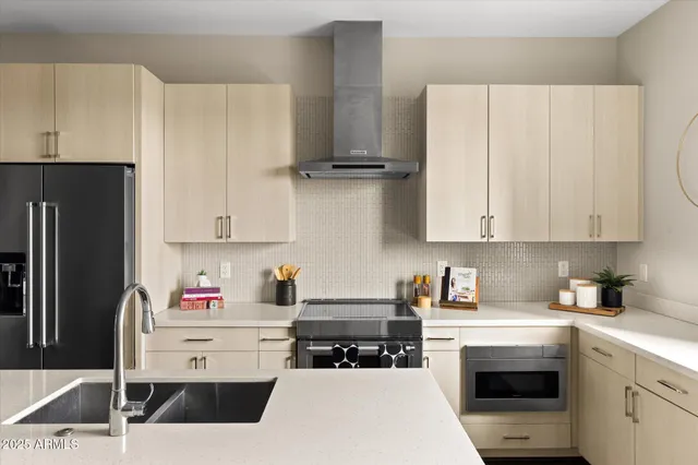 a kitchen with stainless steel appliances a white refrigerator stove a sink and dishwasher