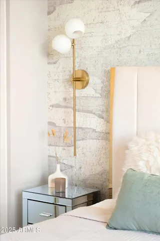 a bedroom with a bed and a painting on the wall