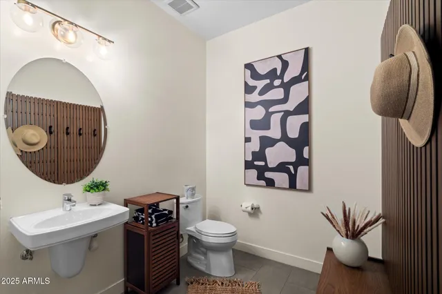 a bathroom with a toilet a sink and mirror