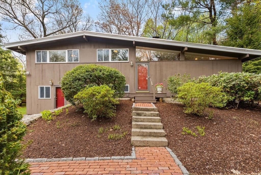 a front view of a house with garden