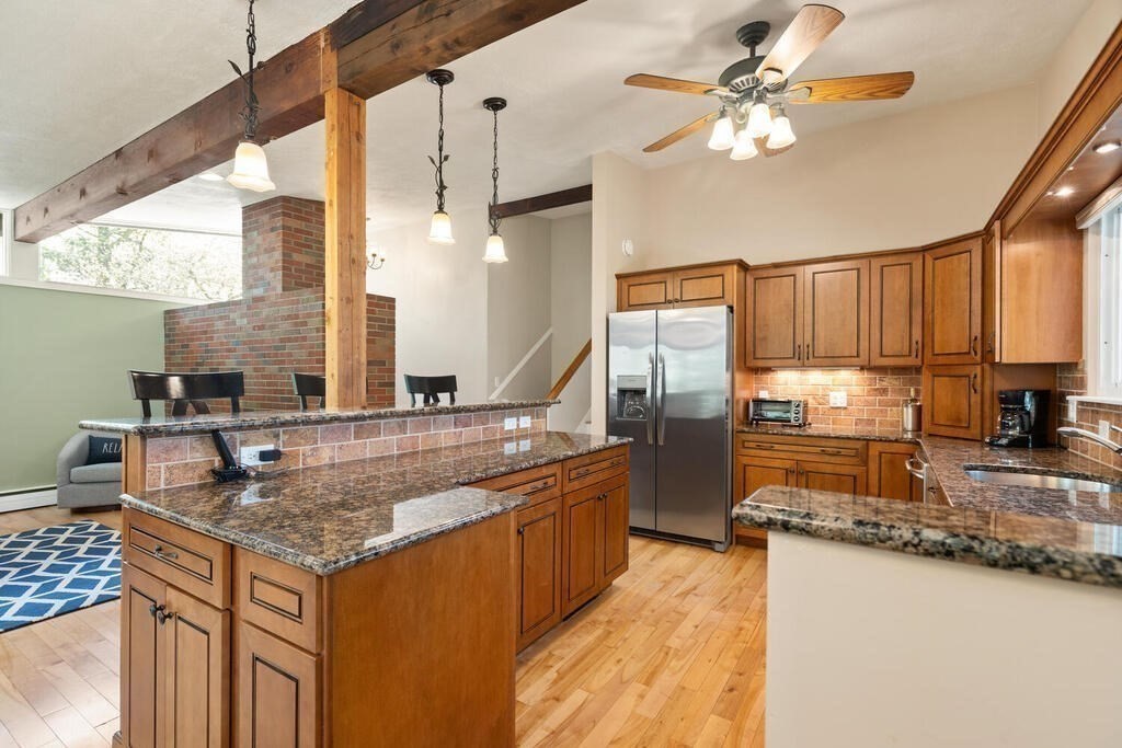 2 Peacock Farm Road Lexington, MA 02421 - Photo 11 of 30 a kitchen with stainless steel appliances granite countertop a sink a stove and a refrigerator