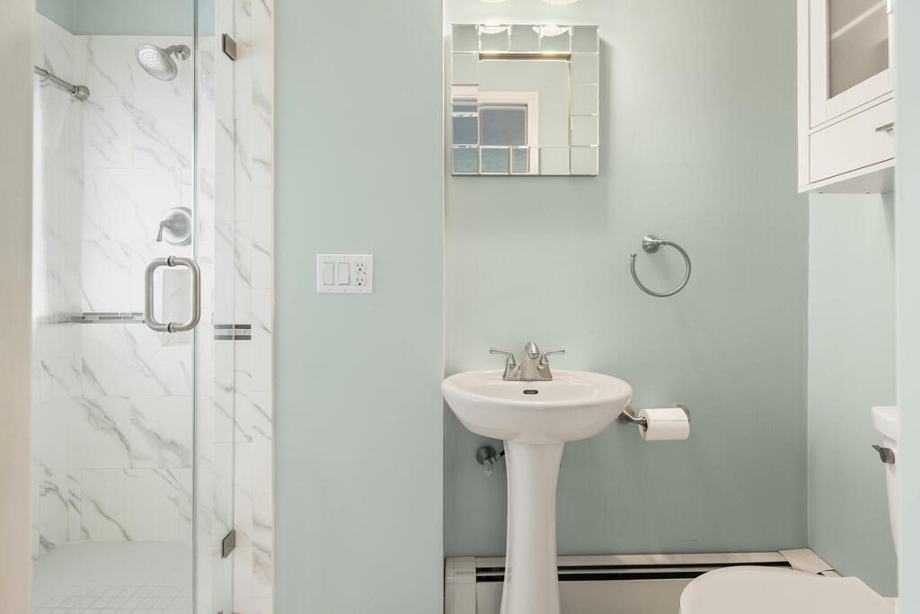 2 Peacock Farm Road Lexington, MA 02421 - Photo 14 of 30 a bathroom with a sink mirror toilet and shower