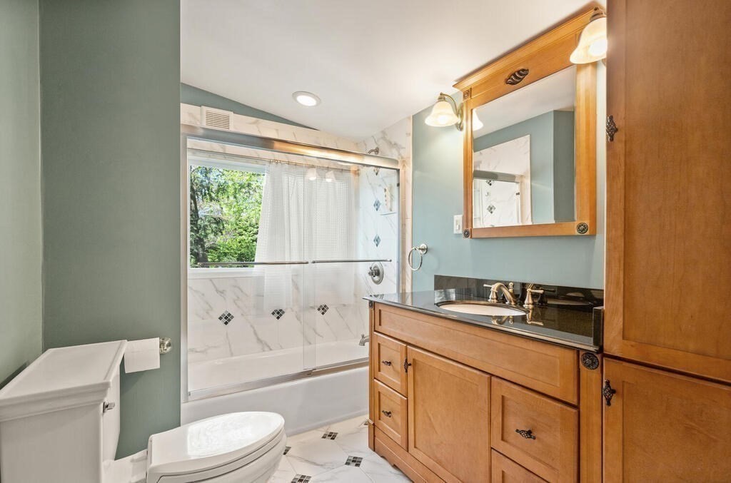 2 Peacock Farm Road Lexington, MA 02421 - Photo 17 of 30 a bathroom with a granite countertop sink toilet mirror vanity and shower