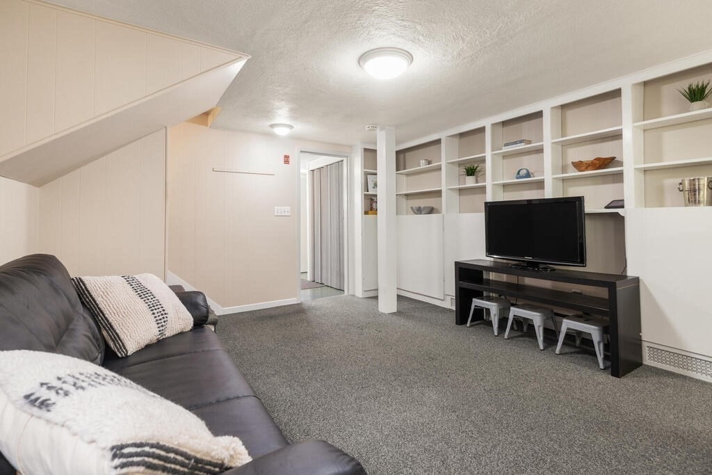 2 Peacock Farm Road Lexington, MA 02421 - Photo 19 of 30 a living room with furniture and a flat screen tv