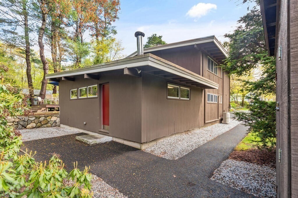 2 Peacock Farm Road Lexington, MA 02421 - Photo 23 of 30 a front view of a house with a garden