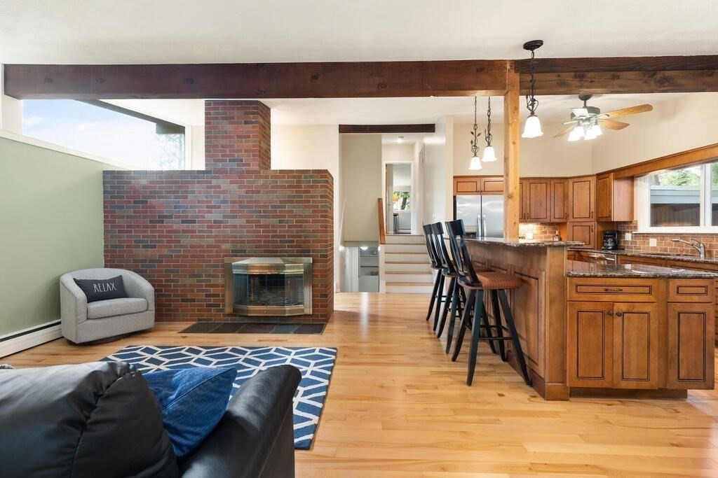 2 Peacock Farm Road Lexington, MA 02421 - Photo 7 of 30 a living room with furniture a wooden floor and a fireplace
