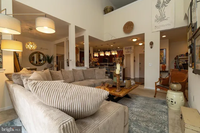 a living room with furniture and a large mirror