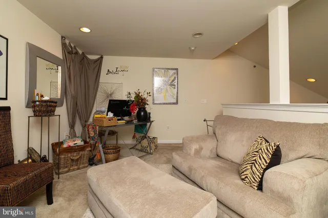 a living room with furniture a fireplace and a large window