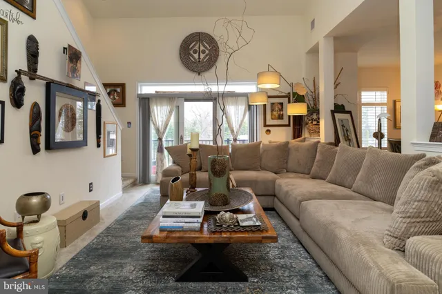 a view of a hallway and a livingroom with furniture
