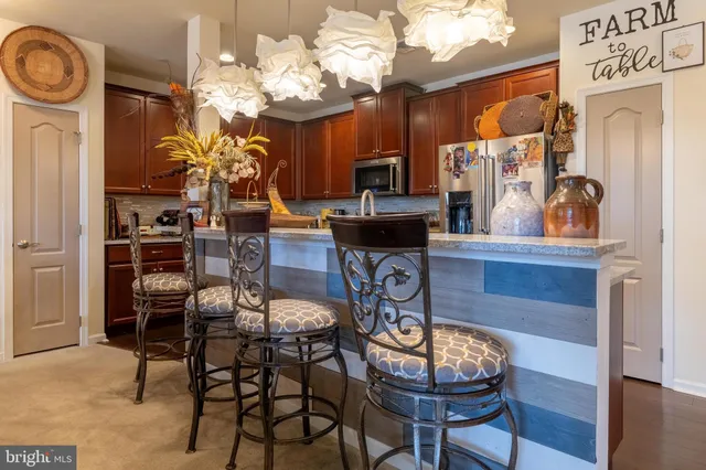 a kitchen with kitchen island granite countertop wooden cabinets and a sink