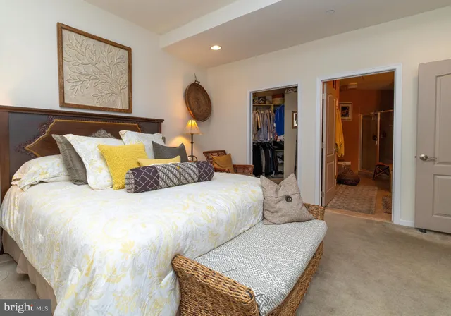 a living room with furniture a flat screen tv and a large window