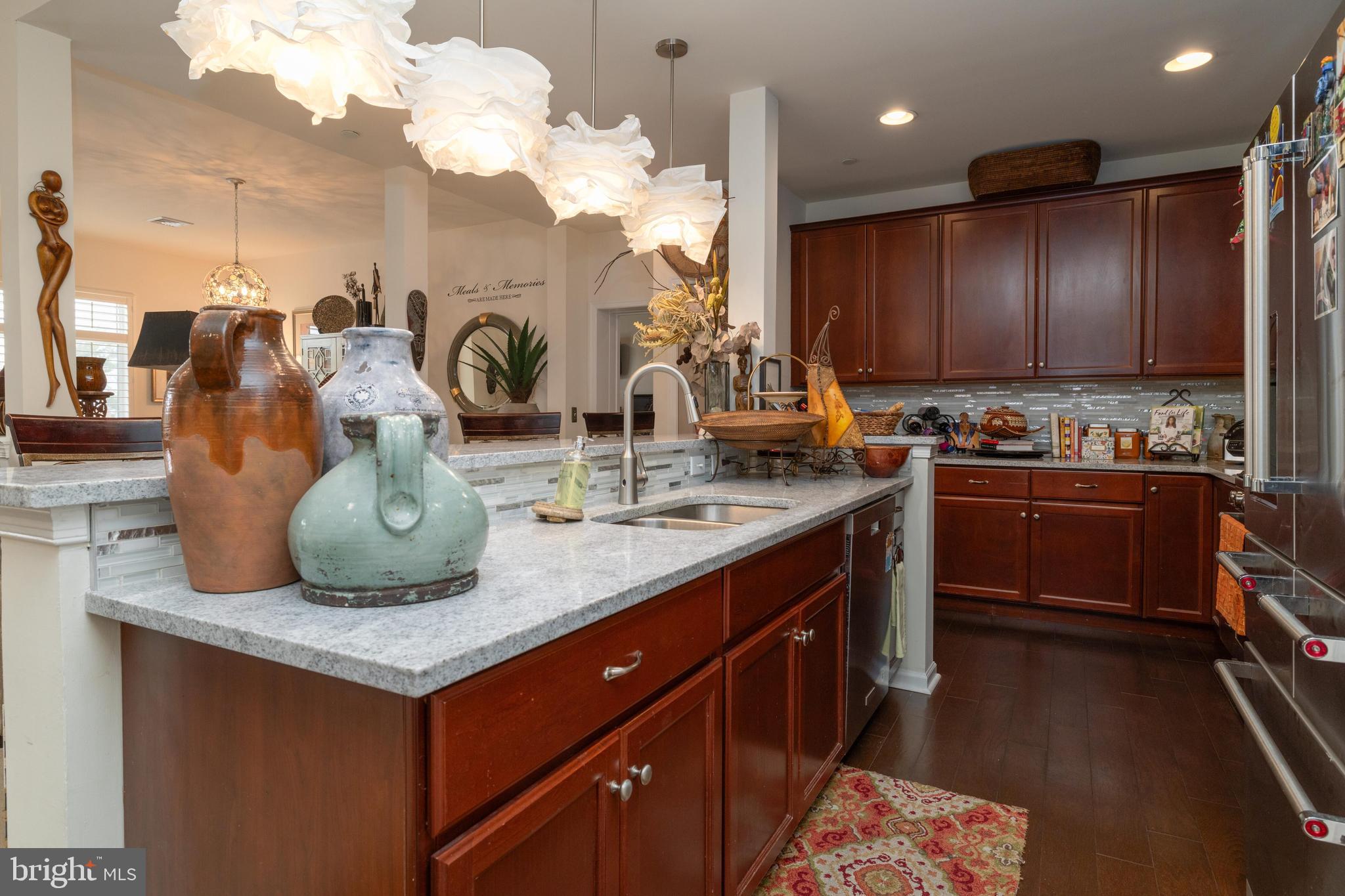 506 Carson Terrace Huntingdon Valley, PA 19006 - Photo 6 of 34 a kitchen with kitchen island granite countertop wooden cabinets and a sink