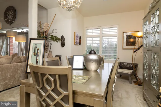 a front view of a multi story residential apartment building with yard and outdoor seating
