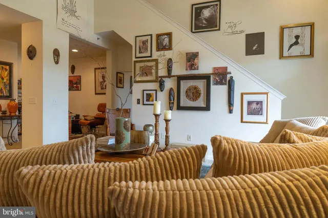 a living room with furniture and a large mirror