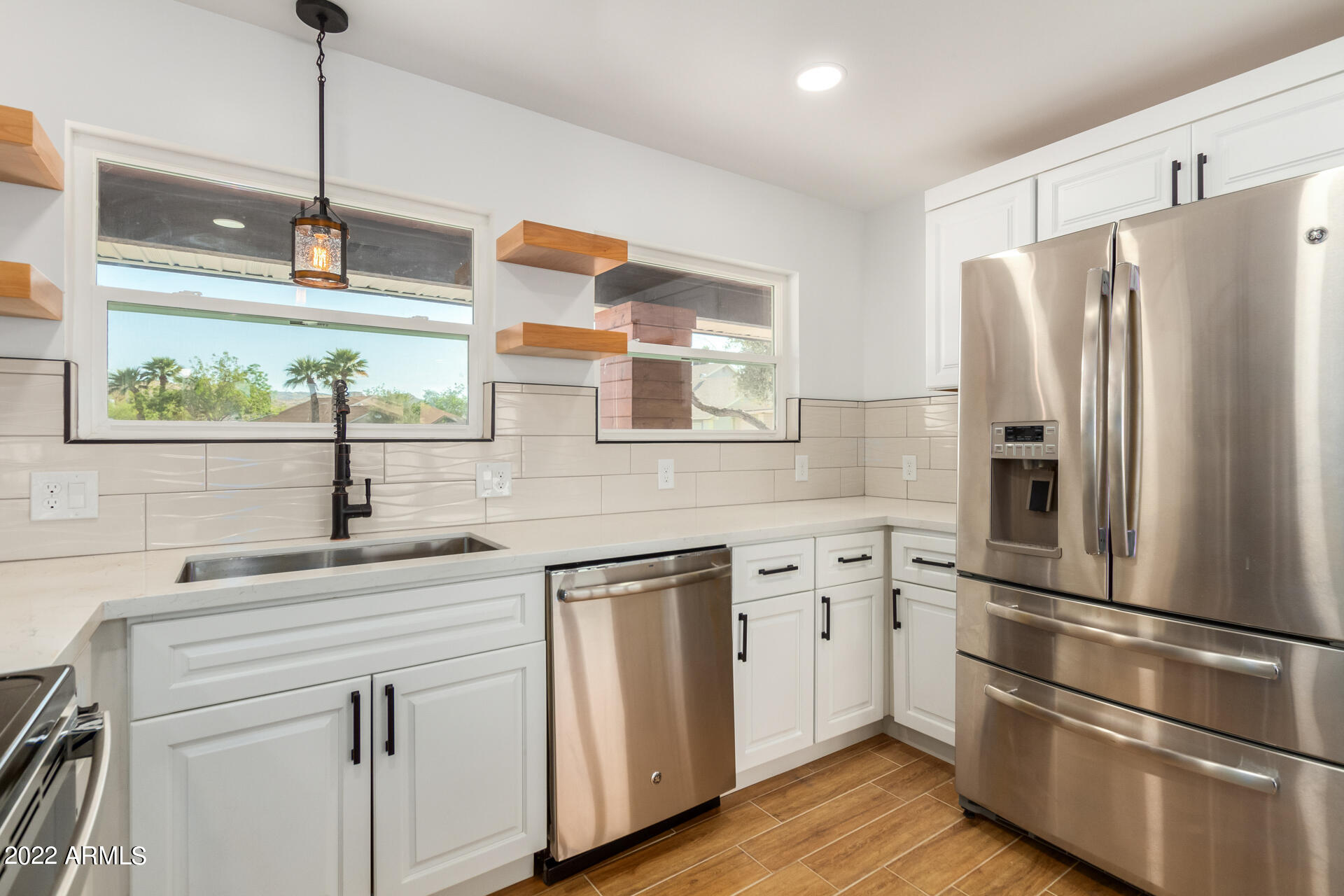 4110 East Vineyard Road Phoenix, AZ 85042 - Photo 11 of 31 a kitchen with appliances cabinets and a sink