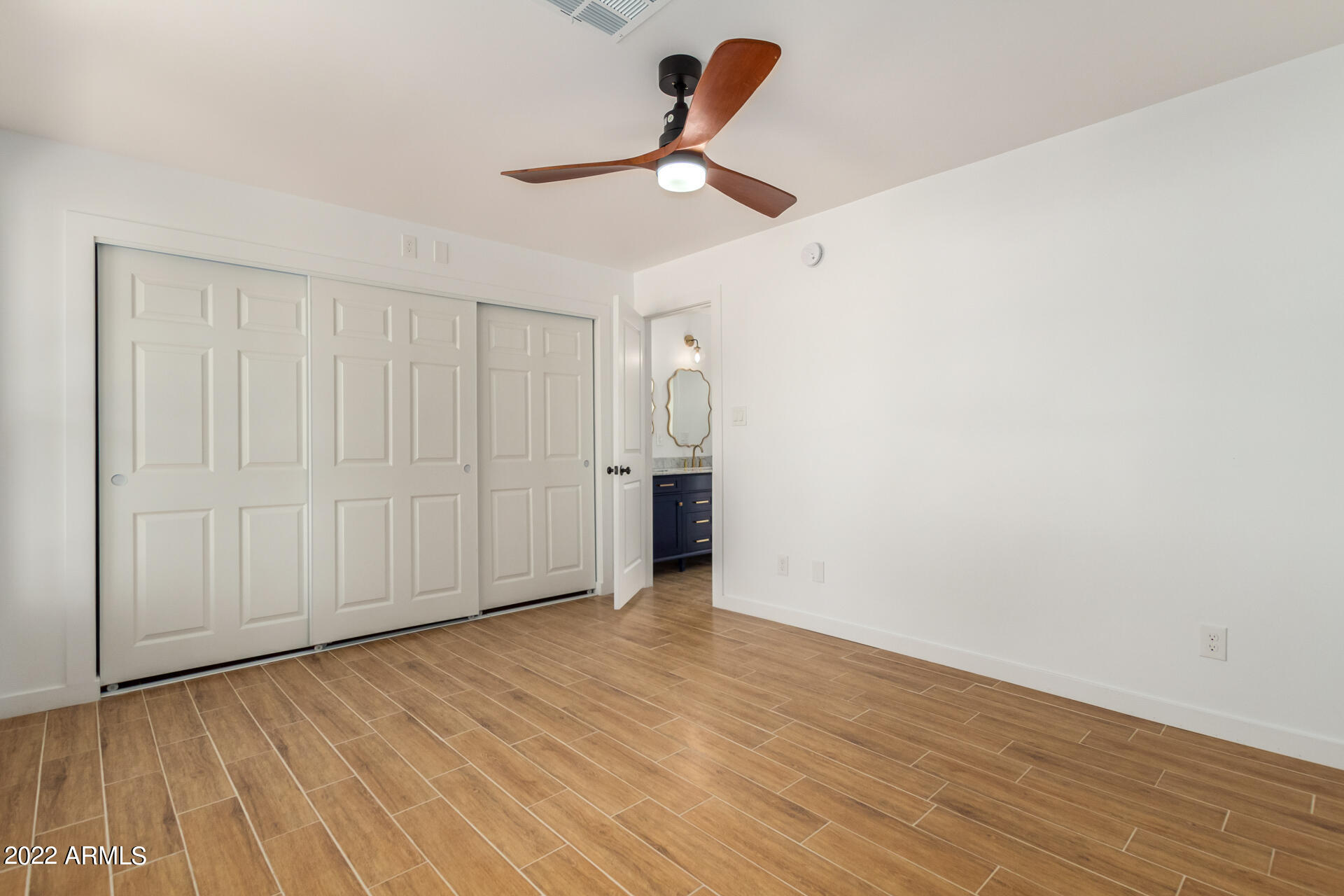 4110 East Vineyard Road Phoenix, AZ 85042 - Photo 18 of 31 a view of empty room with wooden floor